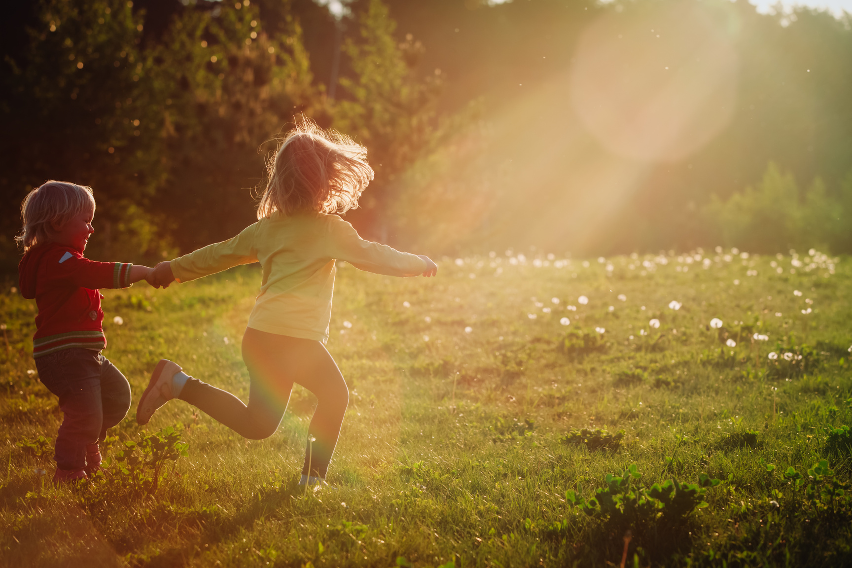 happy kids run play in sunset nature